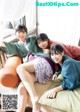 A group of three women sitting on top of a bed.