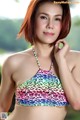 A woman in a colorful bikini posing for a picture.