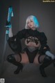 A woman in a black lingerie holding a sword.