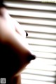 A close up of a person's nose in front of a window.