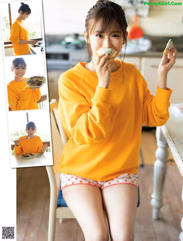 A woman sitting at a table eating a piece of food.