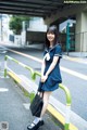 A woman in a school uniform is posing for a picture.