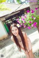 A woman in a pink dress posing for a picture.